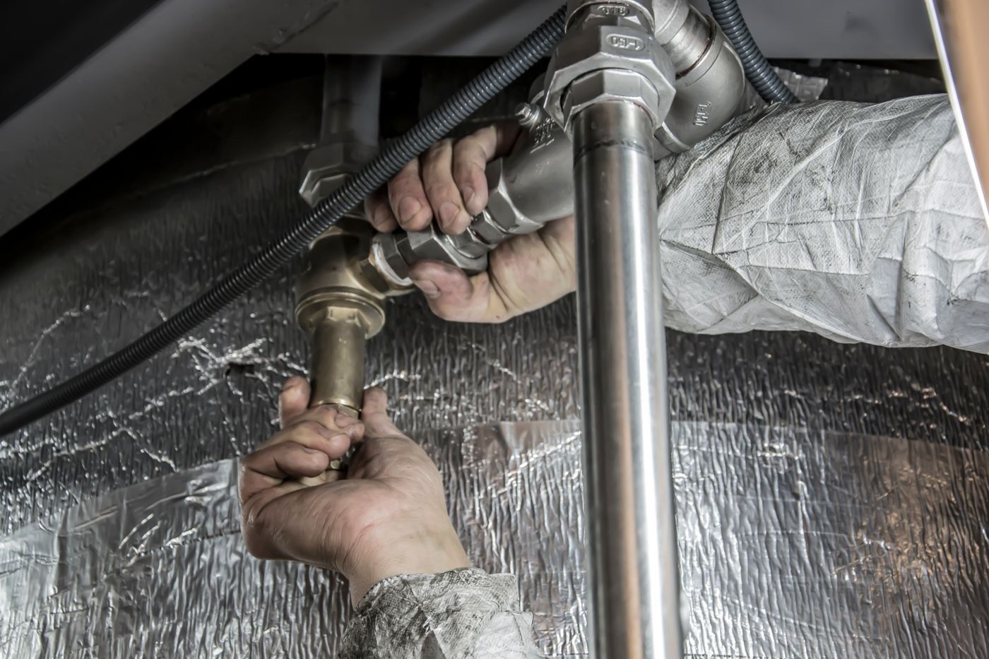 Waste pipe and trap being reconnected under a unit in Edinburgh