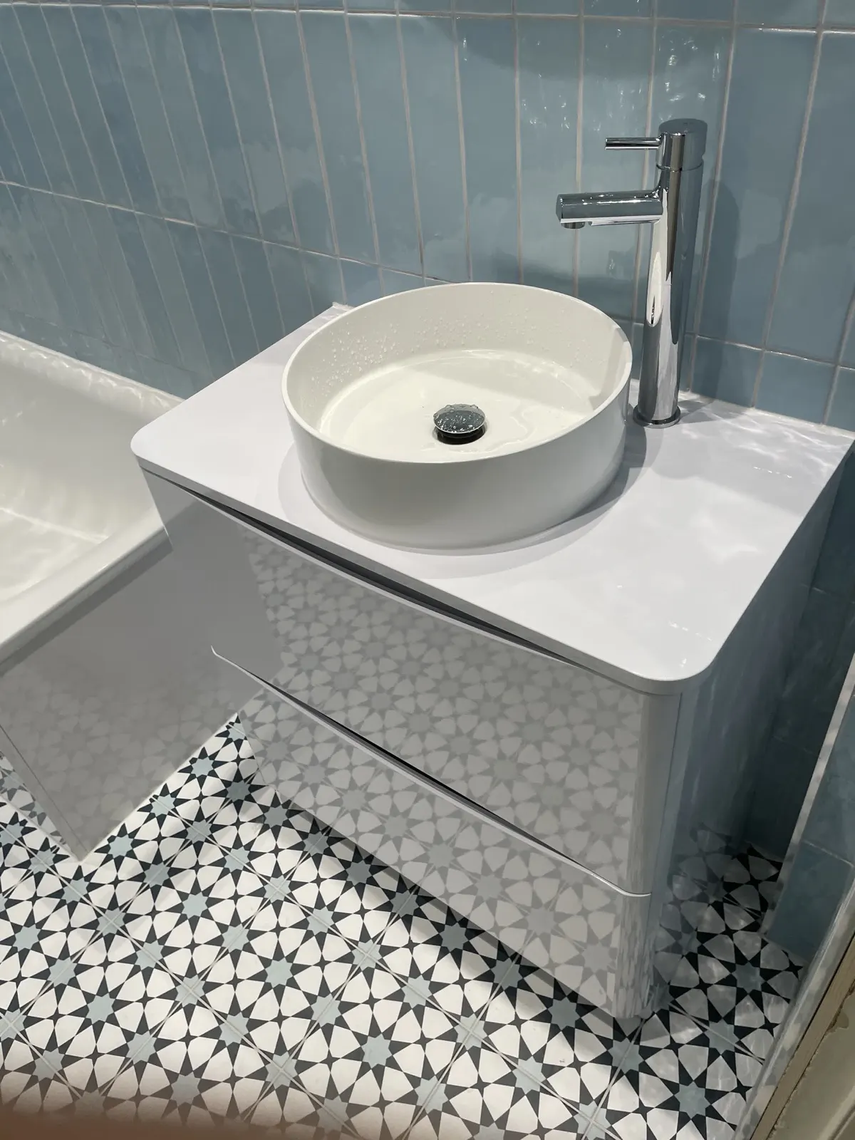 Patterned floor tiling and basin unit fitted by Scott-Eco Builders in Edinburgh